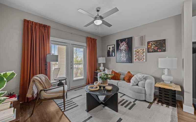 a living room with a fan and couches