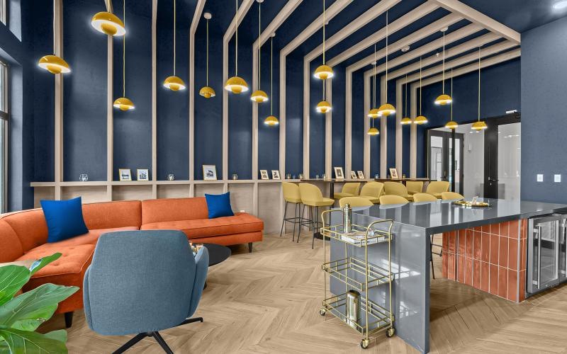 a room with a bar and chairs