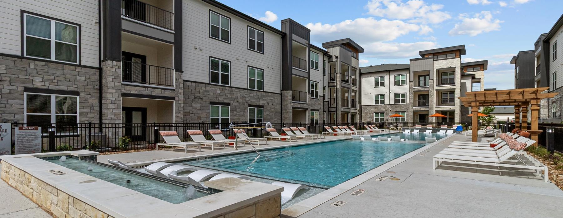 a swimming pool in a courtyard between buildings